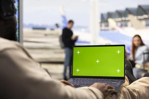 Isolated green screen with black guy digital nomad in airport lounge Stock Photos
