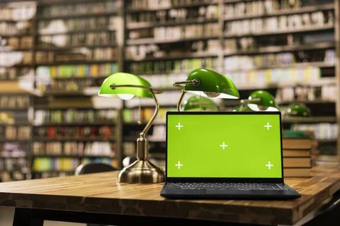Isolated green screen mockup on laptop inside empty library Stockfoto's