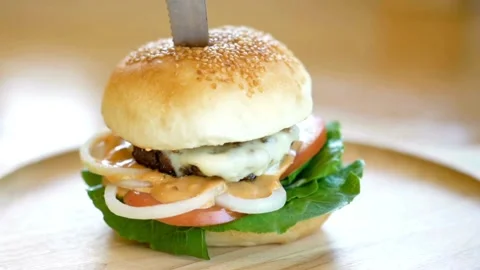 Isolated hamburger rotates on table wood background, and french fries rotating Stock Footage 336579420