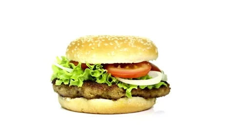 Isolated hamburger rotates on white background, tomatoes. arugula and melted Video stock 336578507