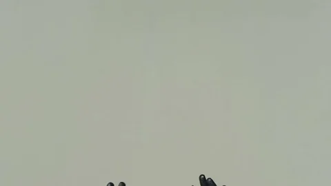 Isolated Hands on gray background completely covered with black paint, decorated Stock Footage 77232099