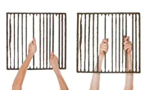 Isolated hands on jail grating Stock Photos