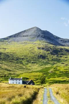 An isolated house beneath Ben More on the Isle of Mull, Scotland, UK. Stock Photos