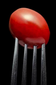 Isolated image of a fork with cherry tomato close-up Stock Photos