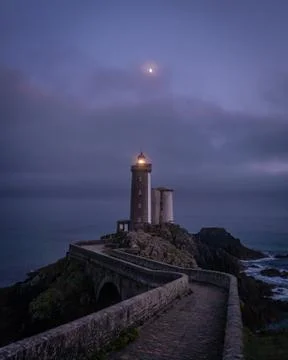 Isolated lighthouse path and moon over Petit Minou tower in France Foto stock