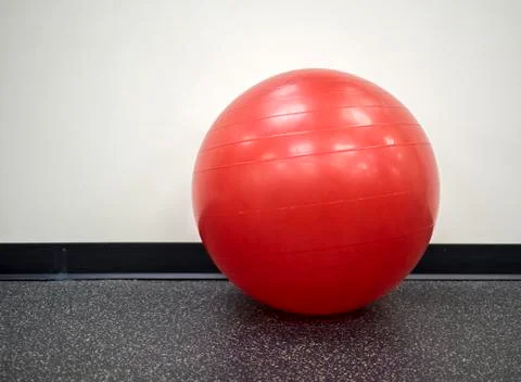 Isolated lone red exercise ball in the gym Stock Photos