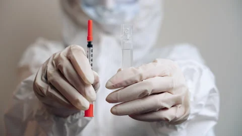 Isolated man holding insulin syringe and ampoule with medication in hands Stock Footage