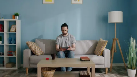 Isolated Man Uses Tablet Computer Stock Footage 129894401