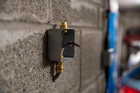 Isolated metal box socket outer case on garage wall ready to be wired Stock Photos