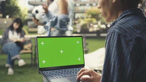 Isolated mockup chroma key shown on laptop as student uses trackpad Stock Photos