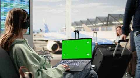 Isolated mockup with digital nomad working on laptop in busy airport lounge Stock Footage 333168895