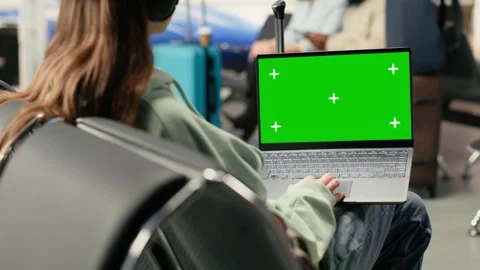 Isolated mockup with digital nomad working on laptop in busy airport lounge Stock Footage 333172925