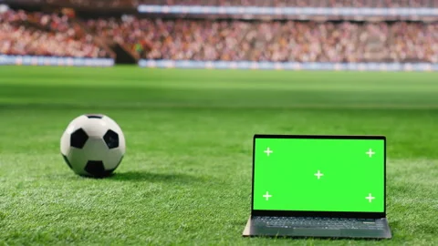 Isolated mockup green screen on laptop near football ball on stadium grass Stock Footage 337997333