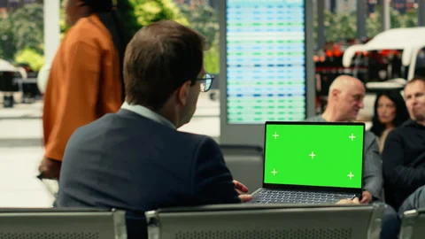 Isolated mockup screen on laptop with man traveler sitting in waiting area Stock Footage 334730984