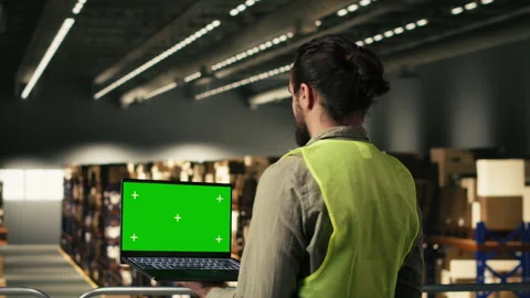 Isolated mockup screen, logistics staff member, laptop in warehouse Stock Footage 330140197