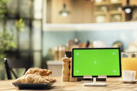 Isolated mockup screen on tablet in empty rustic kitchen with natural light 库存照片