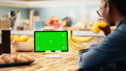Isolated mockup screen on tablet screen in sunlit kitchen at table Stock Footage 344248023