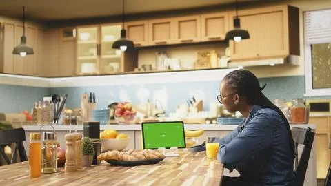 Isolated mockup screen on tablet screen in sunlit kitchen at table Stock Photos
