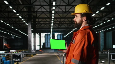 Isolated mockup on tablet held by engineer with helmet in warehouse facility Stock Footage 330088737