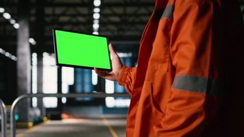 Isolated mockup on tablet held by engineer with helmet in warehouse facility Stock Footage 330376316