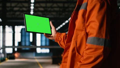 Isolated mockup on tablet held by engineer with helmet in warehouse facility Stock Photos