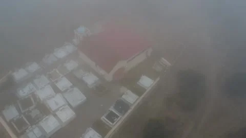 Isolated mountain cemetery with marble tombs hidden in thick fog Stock Footage 344095295