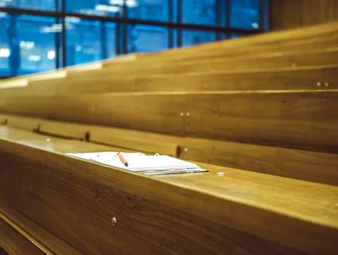 Isolated notebook with pencil on the table in the empty university lecture ha Stock Photos