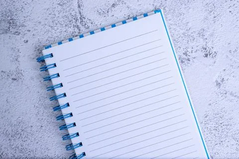 Isolated notebook with stripes on concrete table. Stock Photos