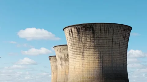 Isolated nuclear cooling tower dominating frame under bright sky with soft 库存影片 335683774