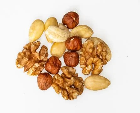 Isolated nuts pattern backdrop. Walnut, cashew, almond and hazelnut on white  스톡 사진
