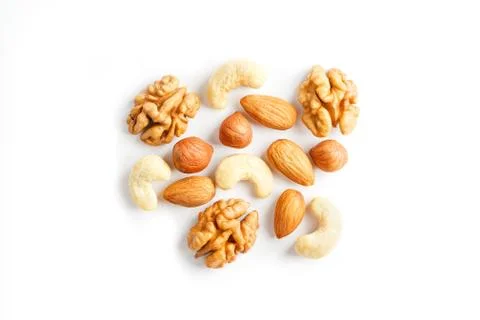 Isolated nuts pattern background. Walnut, cashew, almond and hazelnut on whit 스톡 사진