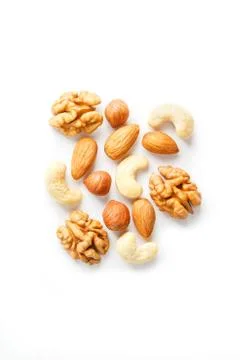 Isolated nuts pattern background. Walnut, cashew, almond and hazelnut on whit 스톡 사진
