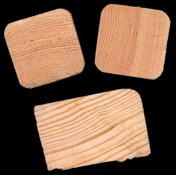 Isolated pine bricks against a black background Stock Photos