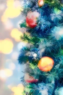 Isolated pine christmas tree branches and orange decorations Stock Photos