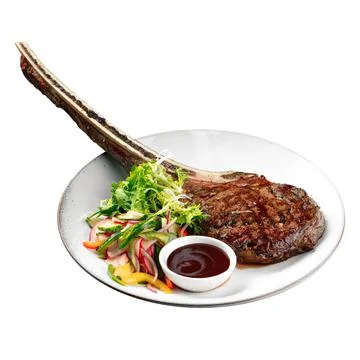 Isolated portion of grilled beef tomahawk steak Stock Photos