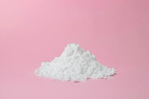 Isolated Powdered Sugar. Sugar powder on a pink background.  Stock Photos
