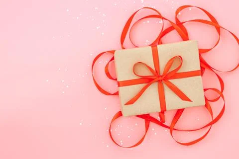Isolated present or gift box in craft paper with red ribbon bow Stock Photos