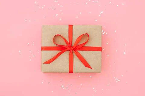 Isolated present or gift box in craft paper with red ribbon bow Stock Photos