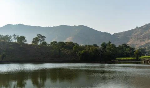 Isolated pristine lake with water reflection at morning from flat angle Фото