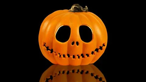 Isolated Pumpkin head Jack-o'-lantern close-up on black background with Stock Photos