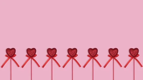 Isolated red hearts dancing on pink background with copy space and loopable Stock Footage 262136978