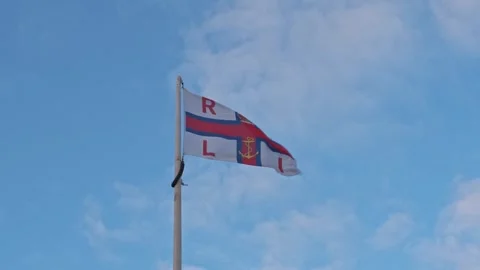 Isolated RNLI flag flapping in the wind Stock-Footage 255854296