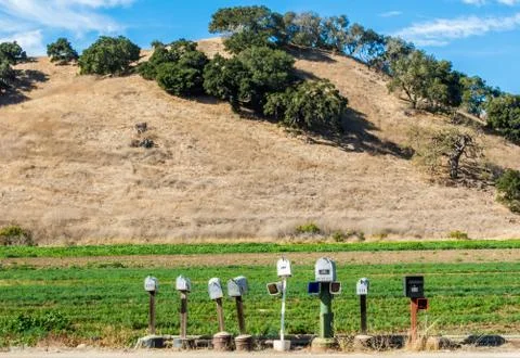 Isolated row of mailboxes in the countryside Stock Photos