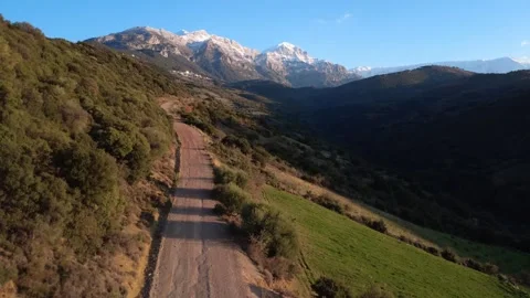 Isolated Rural Path Beneath Snowy Peaks in Europe Stock Footage 321533599