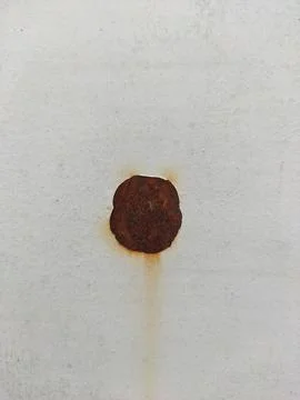 Isolated Rust Spot on a White Surface Stock Photos