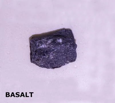 Isolated sample of a Basalt rock on texture background. Basalt Igneous Rock.. Stock Photos