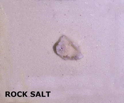 Isolated sample of a rock salt on texture background. Salt Sedimentary Rock.. Stock Photos