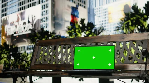 Isolated screen laptop on empty wooden bench outdoors in city park, close up Stock Footage 343553600