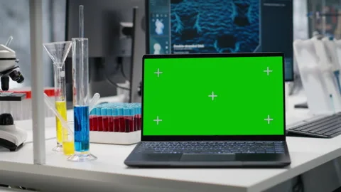 Isolated screen laptop in lab next to test tubes and microscope equipment Stock Footage 320143722
