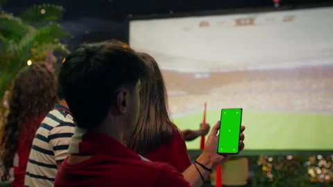 Isolated screen smartphone held by supporter to bet on soccer match Stock Footage 346781068
